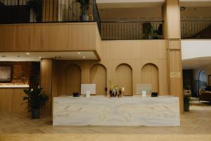 a lobby with a reception desk in a building at Pana Unique Semey in Semey