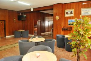 a restaurant with wooden walls and tables and chairs at Hotel Tatrawest in Zuberec