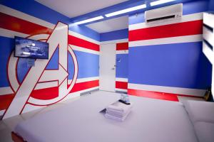 a room with a red white and blue stripes at Astrotel Divisoria in Manila +9 photos