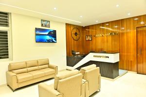 a waiting room with a reception desk and chairs at DOWNTOWN The Mallika Sapphire in Chikmagalūr