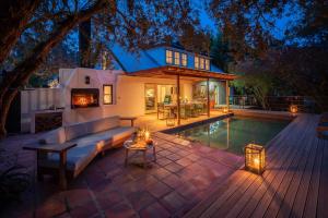 a backyard with a pool and a house at Heron House at Bartholomeus Klip in Hermon