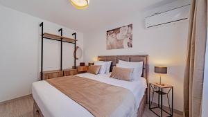 a bedroom with a large bed with white sheets at Villa Antea by Villas Guide in Vela Luka +20 photos