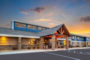 a rendering of a building with a parking lot at AmericInn by Wyndham Bismarck in Bismarck