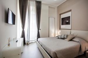 a bedroom with a bed and a large window at Torino Suite in Turin