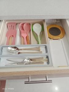 a drawer filled with utensils in a kitchen at Clover88 Studio Room is in the City but with a seaview in Mandaue City