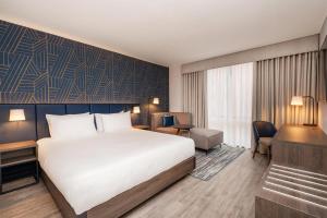 a hotel room with a bed and a desk at Hyatt Place Leeds in Leeds +32 photos