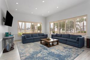 a living room with two blue couches and a table at PaddleTail Waterfront Lodge, Trademark Collection by Wyndham in Crystal River