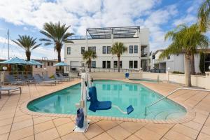 a pool with a slide in front of a building at PaddleTail Waterfront Lodge, Trademark Collection by Wyndham in Crystal River