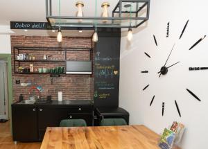 a large clock on the wall in a restaurant at Srafko apartment in Subotica