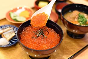 a bowl of red soup with a spoon in it at Onyado Nono Asakusa Natural Hot Spring in Tokyo