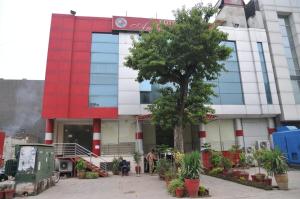a building with a tree in front of it at Ambassador Inn in Islamabad
