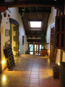 a large room with a vaulted ceiling and a large room with a vaulted at La Posada de Cucayo in Dobres