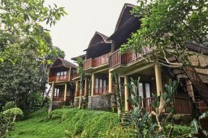 a building with balconies on the side of it at Four Mountains Villa Bedugul by AGATA in Bedugul