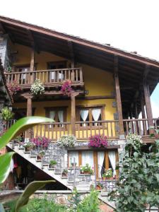 a building with potted plants on the balconies at La Posada de Cucayo in Dobres