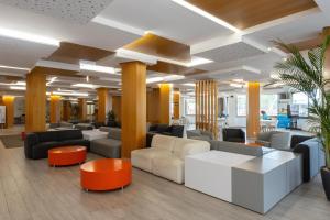 a lobby of a hospital with couches and chairs at Invisa Hotel Es Pla - Adults Only in San Antonio +26 photos