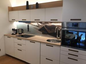 a kitchen with a sink and a microwave at Appartement Sunside in Saalbach-Hinterglemm