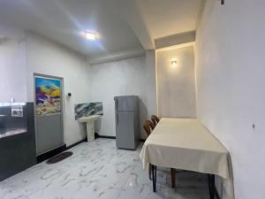 a room with a table and a refrigerator in it at Budget Comfort Villas in Boragasketiya +37 photos