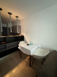 a living room with a white table and a couch at GALAXY apartment in Sofia