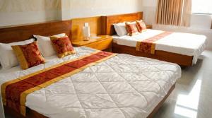a hotel room with two beds in a room at Khách Sạn Ngọc Châu in Lấp Vò