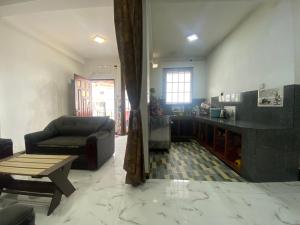 a living room with a couch and a table at Budget Comfort Villas in Boragasketiya