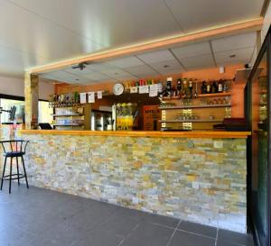 a bar in a restaurant with a brick wall at Mobil-home dans camping aquatique in Hyères