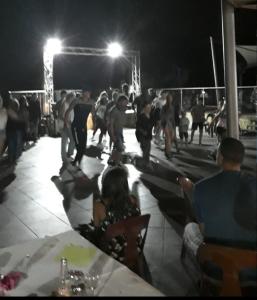 a group of people on the beach at night at Mobil-home dans camping aquatique in Hyères +16 photos