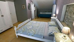 a bedroom with a large bed with a blue comforter at Villa Buby by Villas Guide in Kraljevica +18 photos
