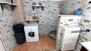 a small bathroom with a washing machine in it at Villa Buby by Villas Guide in Kraljevica