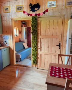a living room with a sliding door and a couch at Islandzka chatka- Jacuzzi i sauna w cenie in Mżyki +52 photos