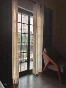 a room with a window with a view of a balcony at Konwar Inn & Suites in Golāghāt