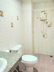a bathroom with a toilet and a sink at Krabi Hotel Agency in Krabi