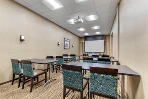 a conference room with tables and chairs and a whiteboard at Comfort Suites San Antonio Ft Sam Houston-SAMMC Area in San Antonio +25 photos