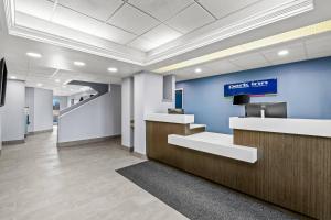 an office lobby with a reception desk and blue wall at Park Inn by Radisson, Grand Island I-80 in Grand Island