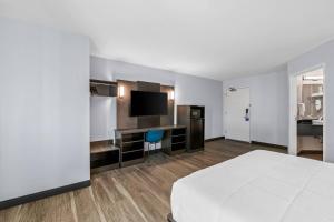 a hotel room with a bed and a flat screen tv at Park Inn by Radisson, Grand Island I-80 in Grand Island +31 photos