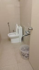 a bathroom with a toilet with the seat up at AB Residency in Chennai