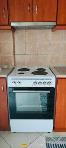 a white stove top oven in a kitchen at EvropisHouse in Kozani