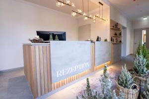 a reception counter in a store with potted plants at Waldhotel Hohe Sonne Eisenach in Eisenach