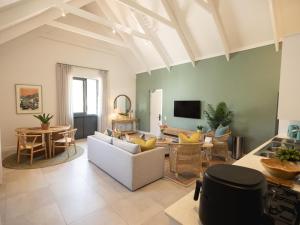a living room with a couch and a table at Cornercade | Unit 1 in Hermanus