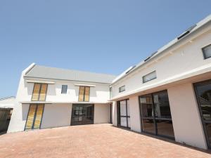 a large white building with a lot of windows at Cornercade | Unit 1 in Hermanus