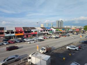a city street with cars parked in a parking lot at Sleepy Bear Capsule Hostel in Johor Bahru
