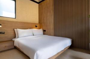 a bedroom with a large white bed in it at NOMAD Chic Private Pool Loft in Canggu, all inclusive stay in Dalung