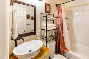 a bathroom with a sink and a toilet and a mirror at Kettlestone in Stanton +117 photos