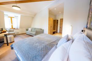 a bedroom with a bed and a living room at Waldhotel Hohe Sonne Eisenach in Eisenach