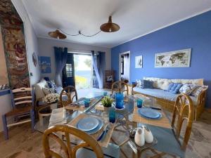 a living room with a table and a couch at Sicily Sea Villa Capo Zafferano in Santa Flavia