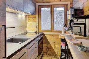 a small kitchen with a sink and a stove at Ferienhaus Gasteg in Maria Alm am Steinernen Meer