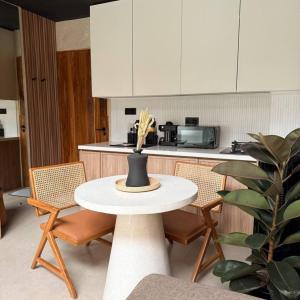 a kitchen with a table and chairs and a counter at NOMAD Chic Private Pool Loft in Canggu, all inclusive stay in Dalung