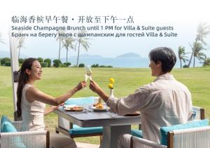 a movie poster of a man and a woman sitting at a table at The St. Regis Sanya Yalong Bay Resort in Sanya