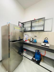 a kitchen with a stainless steel refrigerator at Serandib Town Apartment in Weligama +15 photos