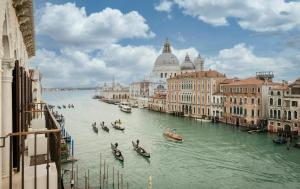 a group of gondolas on a river in a city at Maison Spada in Venice