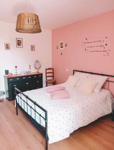 a bedroom with a large bed and a chair at Le coin des Samariens - Étape Saint-Jacques in Golinhac +2 photos